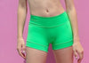 Green high-waisted dance shorts shown from the front on a model