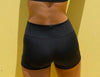 Black fitted dance shorts shown from the back on a model