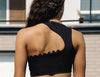 Black asymmetrical dance crop top with scalloped edge detail shown from the back