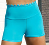 High-waisted turquoise dance shorts with scalloped waistband detail shown from the front