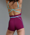 Color-blocked dance jumpsuit with contrast piping shown from the back
