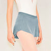 Adult ballet dancer wearing a muted blue pull-on ballet skirt over a leotard
