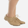Tan lace-up tap shoe worn on dancer’s foot