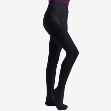 Child wearing black footed dance tights, full leg view