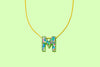 Additional product image showing a colorful confetti letter necklace.