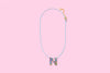 Additional product image showing a colorful confetti letter necklace.