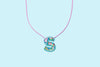 Additional product image showing a colorful confetti letter necklace.