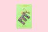 Confetti letter E acrylic keychain on a pink backer card with gold keyring