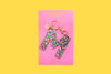 Confetti letter M acrylic keychain on a pink backer card with gold keyring