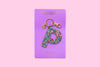 Confetti letter P acrylic keychain on a purple backer card with gold keyring