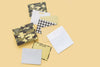 Taylor Elliott camo and gingham boxed note card set with envelopes displayed on yellow background