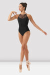 Adult dancer wearing black printed halter dance leotard, angled view