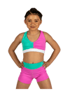 Young dancer wearing teal and pink dance shorts with matching crop top, standing facing forward.