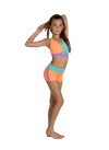 Young dancer wearing coral and teal dance shorts with coordinating crop top.