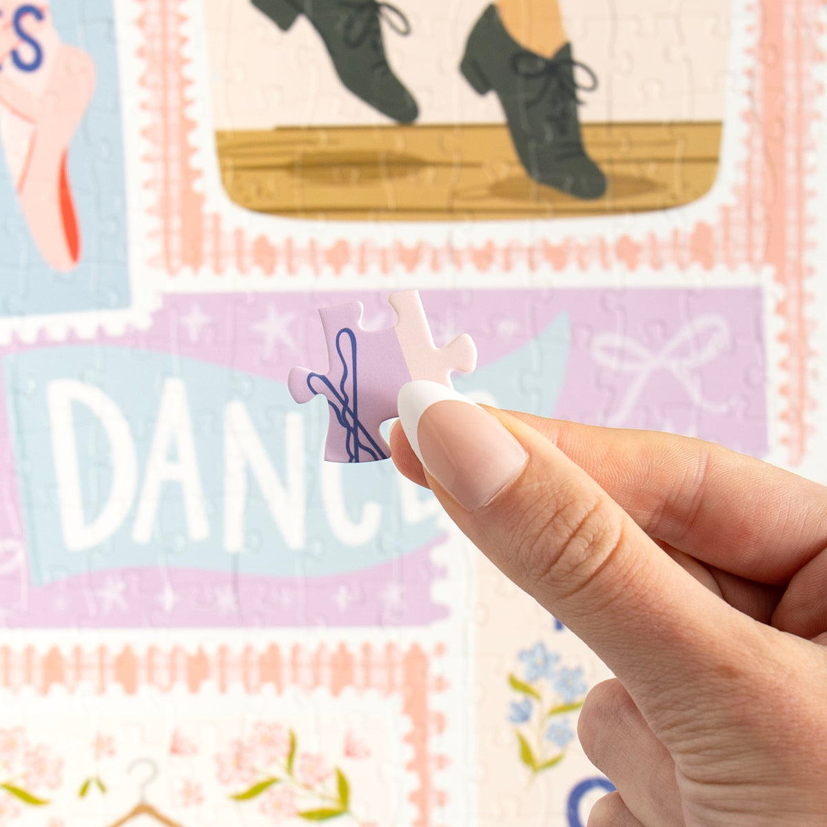 Dance It Out puzzle featuring illustrated ballet slippers, dance quotes, and colorful artwork