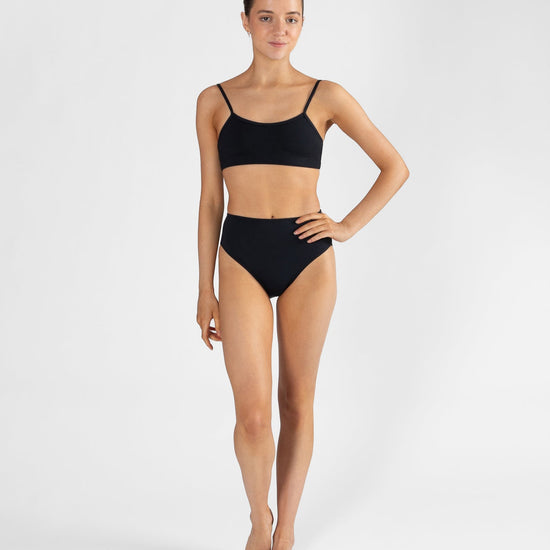 Woman wearing a black bikini set on a white background