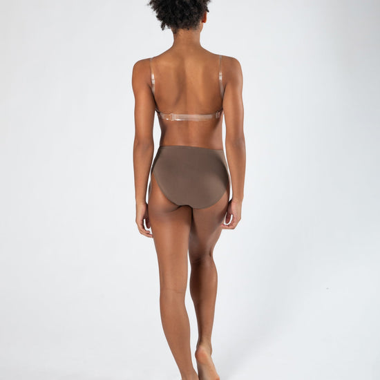 Model wearing a darker-toned high cut dance brief with matching bra, back view