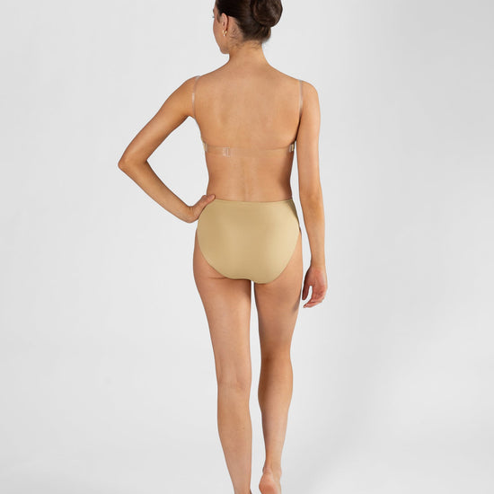 Full body back view of model wearing nude high cut dance brief and matching bra