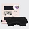 Black weighted satin eye mask displayed in front of its product packaging