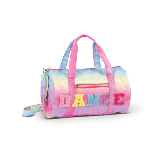 Pastel rainbow quilted dance duffel bag with pink straps and “DANCE” lettering