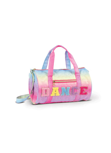 Pastel rainbow quilted dance duffel bag with pink straps and “DANCE” lettering