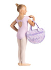 Side view of young dancer holding a lavender dance tote bag