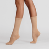Silky Dance compression turning socks shown in nude color on dancer legs