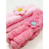 Mixed color daisy spa headbands displayed flat