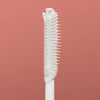 Close-up of the clear applicator brush used for styling and taming 