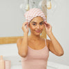 Model adjusting the fit of a satin-lined flexi shower cap