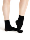 Child wearing black ribbed crew dance socks