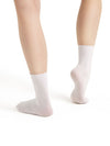 Child wearing white ribbed dance socks pulled above the ankle