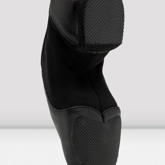 Sole view of a black slip-on leather jazz shoe showing the split sole.