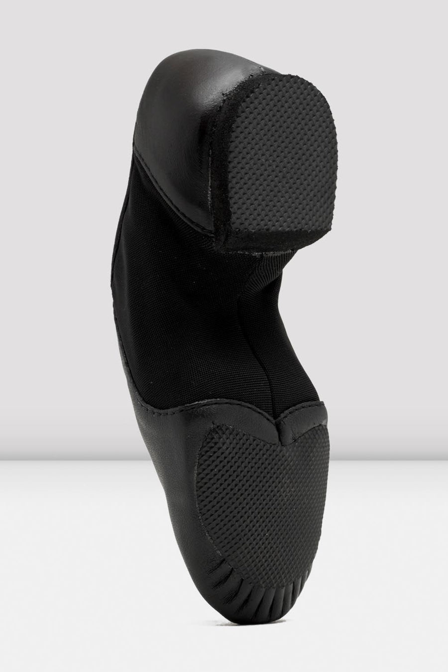 Sole view of a black slip-on leather jazz shoe showing the split sole.