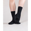 Side view of dancer wearing black dance socks showing ankle height