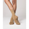 Dancer wearing tan dance socks posing in a leotard