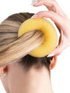 Blonde bun builder placed over ponytail for ballet bun