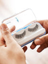 Hands opening a false eyelash case with lashes inside