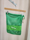Green mesh FTT logo shoe bag hanging on rack