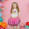 Young girl modeling raspberry pink confetti tutu skirt with coordinating outfit