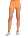 Dancer wearing orange boy cut shorts, front view