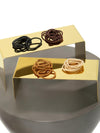 Assorted Capezio Bunheads hair ties displayed on gold platforms with multiple hair colors