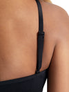 Close-up view of black camisole bra top showing adjustable shoulder strap detail