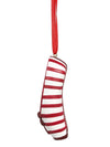 Side view of a red and white striped pointe shoe ornament hanging by a red ribbon.
