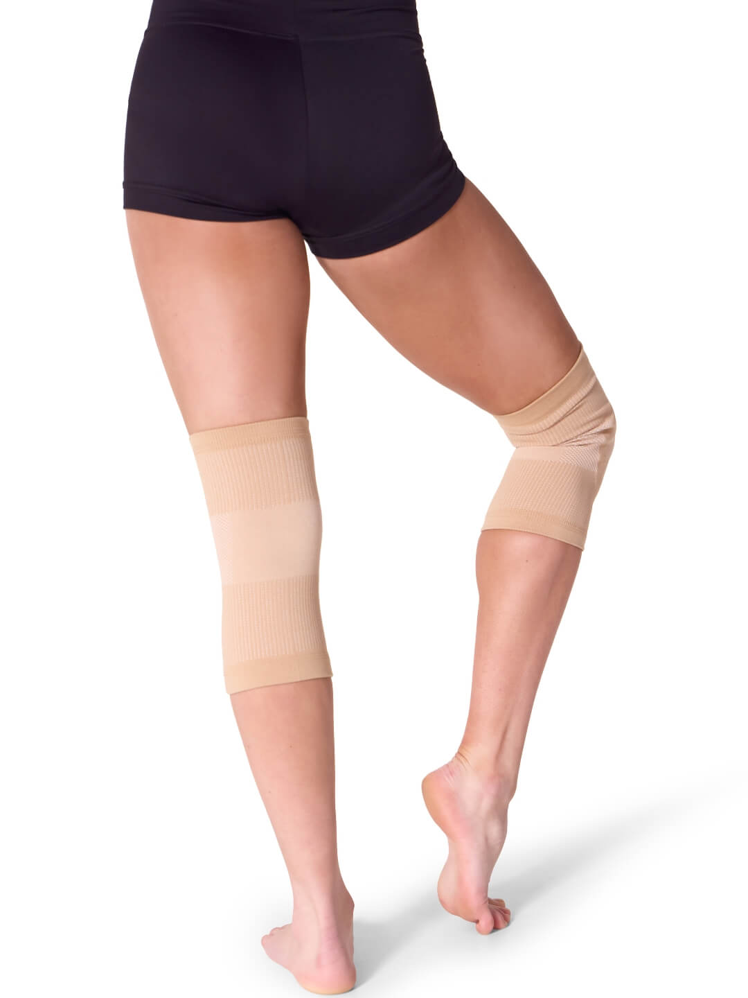 Nude gel dance kneepad worn on one leg from the back view.