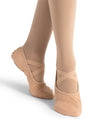 Dancer wearing nude split-sole canvas ballet shoes viewed from the back