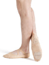 Side view of dancer wearing nude canvas ballet shoes with elastic fit