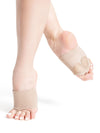 Beige lyrical foot undeez with suede sole patches worn on dancer’s foot