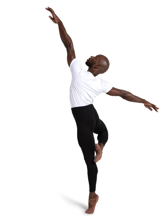 Male dancer wearing black leggings and a white shirt performing a dance pose on a white background