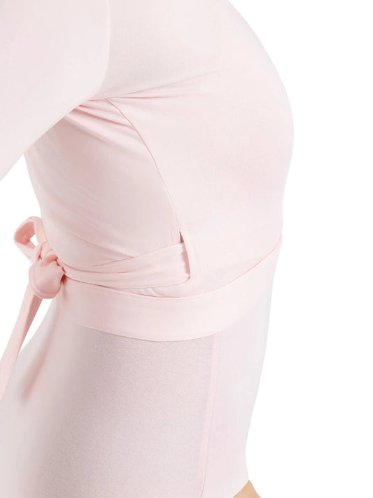 Close-up side view of a wrap top tied at the waist over a leotard